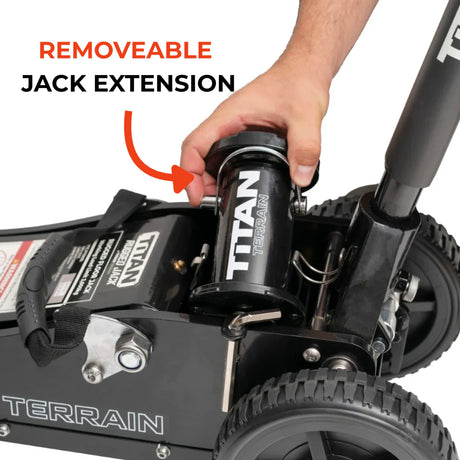 Hand holding a removeable jack extension on a Titan Terrain vehicle.
